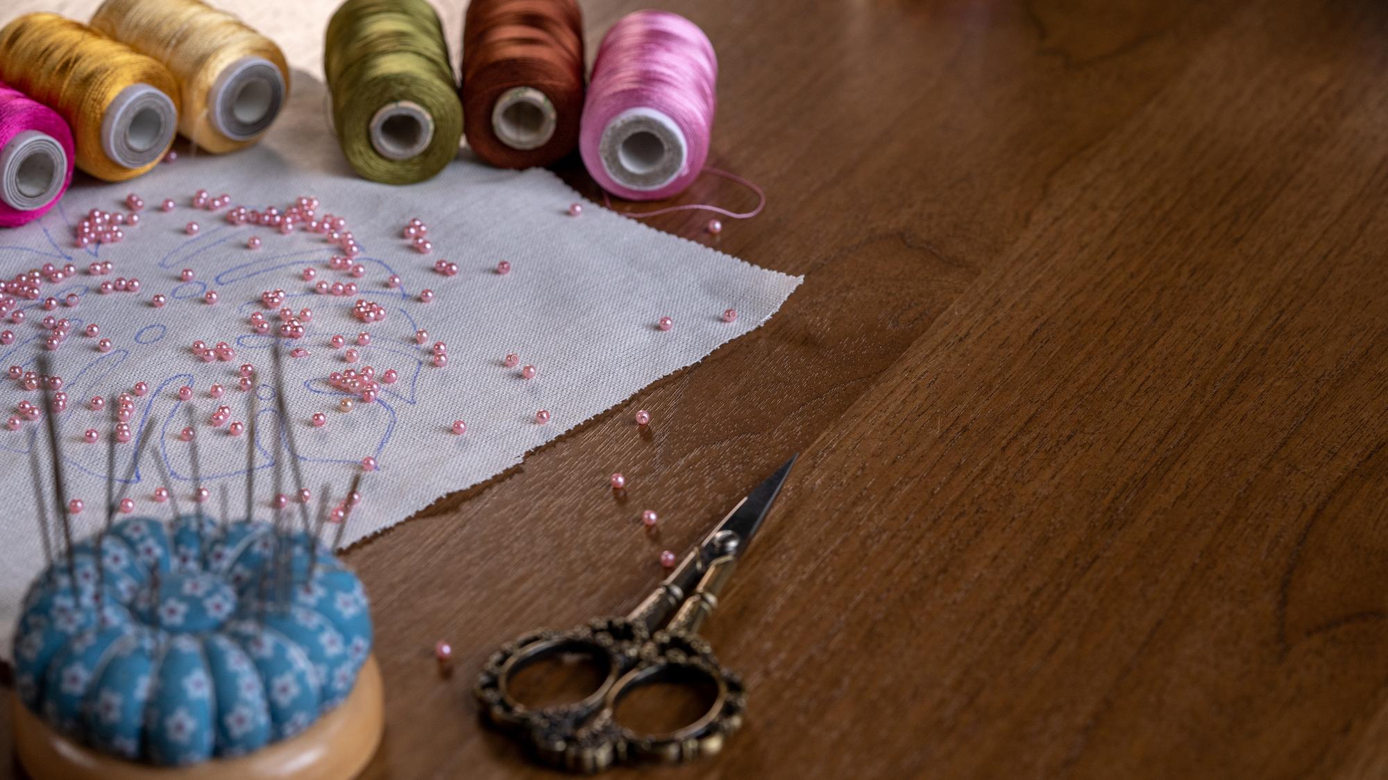 atelier table with threads and embroidered swatches